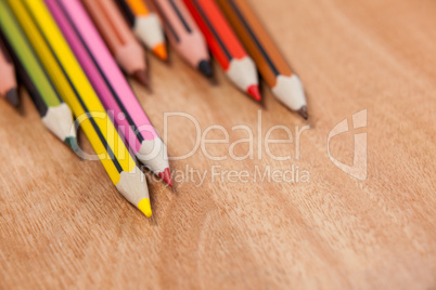 Close-up of colored pencils arranged in a wave pattern