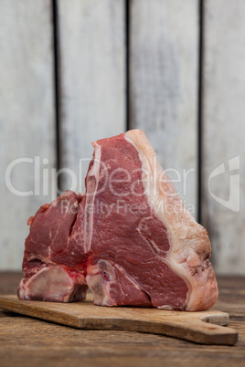 Sirloin chop on wooden board