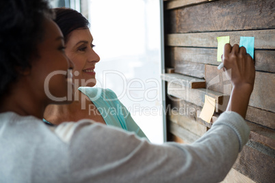 Man and woman discussing over desktop pc