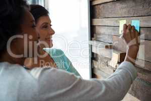 Man and woman discussing over desktop pc