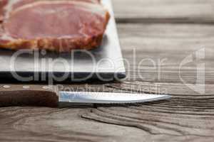 Sirloin chop on black slate plate with knife