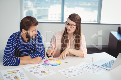 Graphic designers interacting with each other