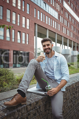 Smiling executive having veg roll and juice