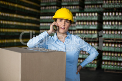 Female factory worker talking on mobile phone