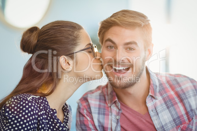 Affectionate woman kissing man