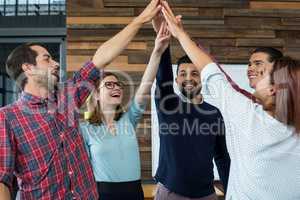 Team of businesspeople giving high five