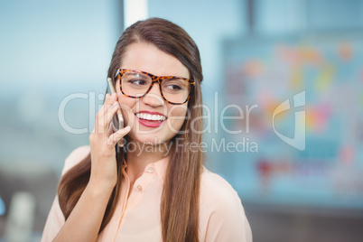 Female executive talking on mobile phone