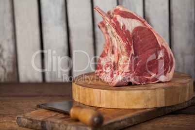 Rib rack and knife on wooden board