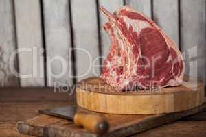 Rib rack and knife on wooden board