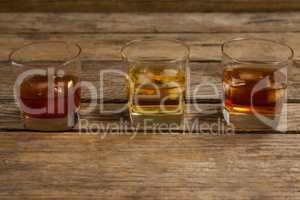 Three glasses of whiskey with ice cube