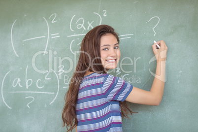 Portrait of schoolgirl pretending to be a teacher in classroom