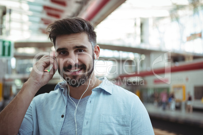Smiling executive listening to music on headphones