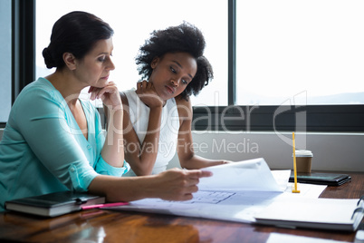 Female graphic designers looking at the document