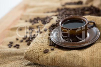 Black coffee served on sack with coffee beans