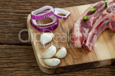 Blade chop, onions and garlic on wooden board