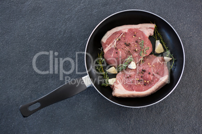 Sirloin chop and herbs in frying pan
