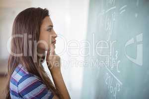 Schoolgirl pretending to be a teacher in classroom