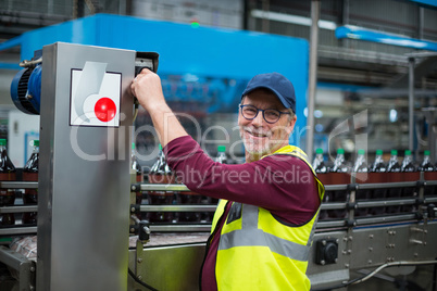 Portrait of factory worker operating machine