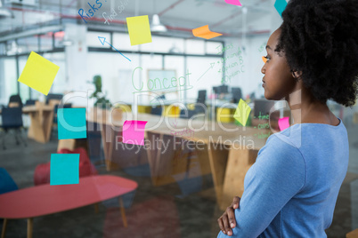 Female graphic designer looking at the glass