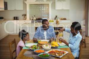 Family having meal on dinning table at home