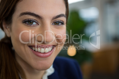 Smiling female executive in creative office