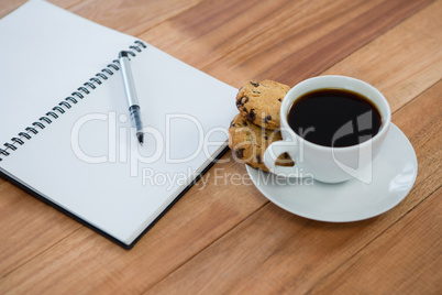 Open diary with pen and black coffee