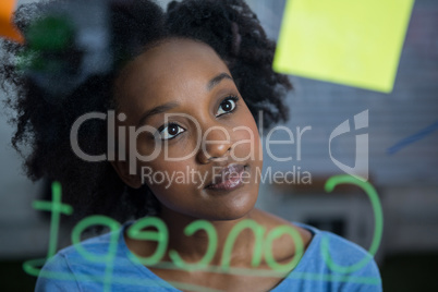 Female graphic designer looking at the glass