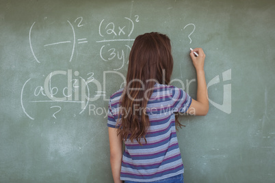 Rear view of schoolgirl pretending to be a teacher in classroom