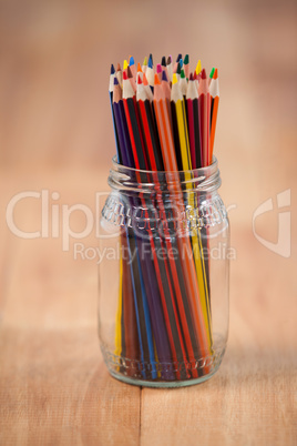 Colored pencils kept in a glass jar