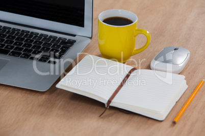 Cup of coffee with laptop, organizer, pencil and mouse