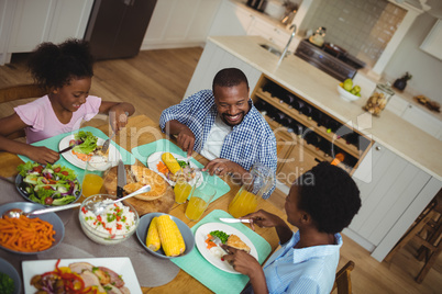 Family having meal on dinning table at home