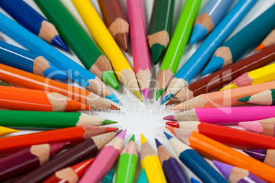 Close-up of colored pencils arranged in a circle