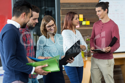 Business executives discussing over file during meeting