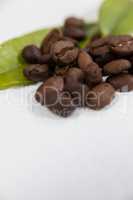 Roasted coffee beans with coffee leaves