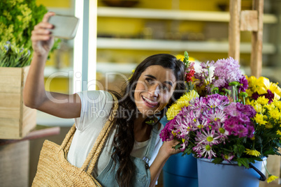 Woman taking a selfie at florist shop