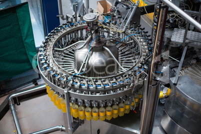 Bottles being filled with juice on production line