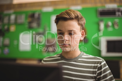 Schoolboy studying in computer classroom