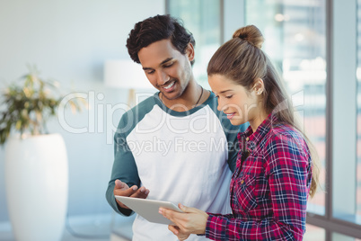 Executives using digital tablet in office