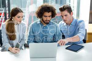 Business executive discussing over laptop in meeting