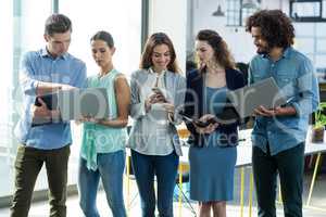 Group of business executives using digital tablet, mobile phone and laptop