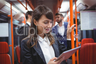 Executive using digital tablet in train