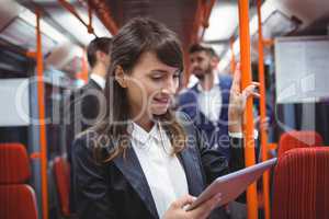Executive using digital tablet in train