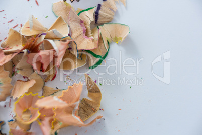 Colored pencils shavings on a white background