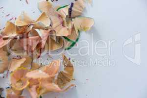 Colored pencils shavings on a white background