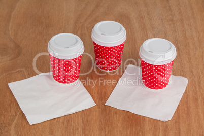 Three disposable coffee cup with tissue paper
