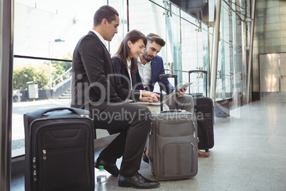 Business executives using laptop on platform