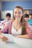 Student holding digital tablet in classroom