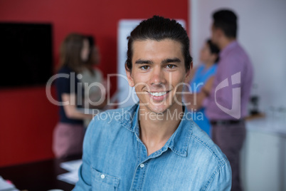 Portrait of smiling business executive at meeting