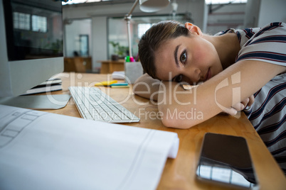 Overworked graphic designer sleeping on his desk