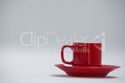 Close-up red coffee cup and saucer